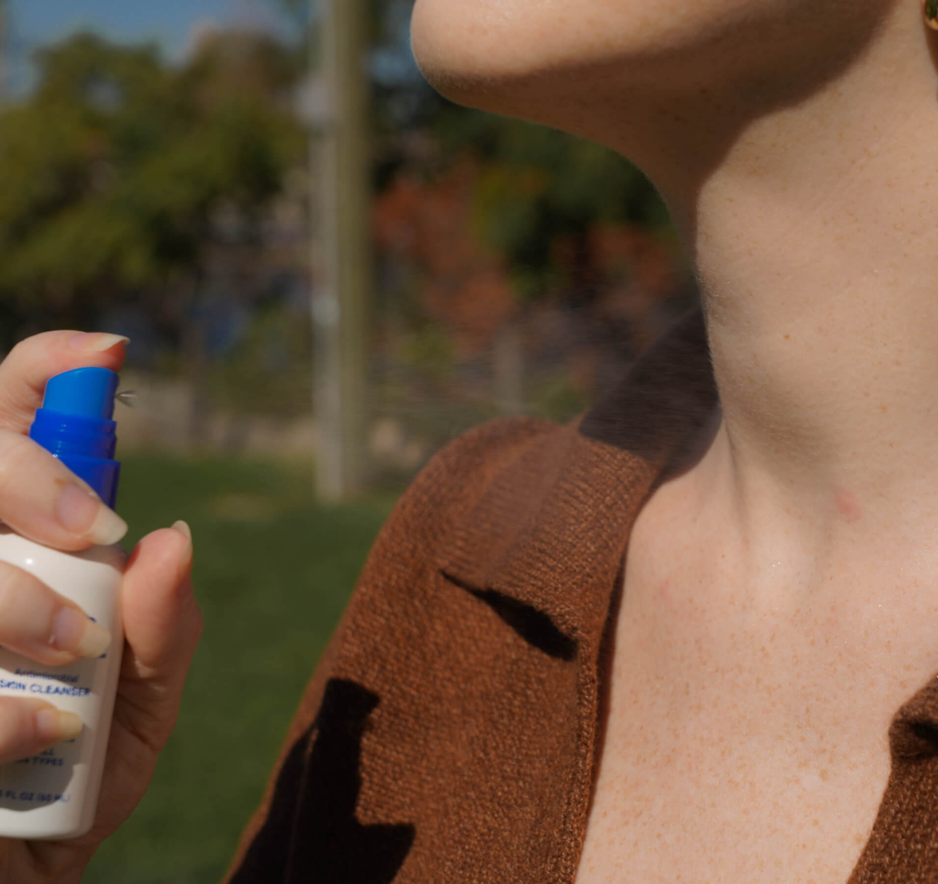 Person spraying Magic Molecule on a bug bite